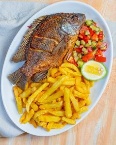 a fish and fries on a white plate