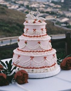 a three tiered wedding cake on top of a table