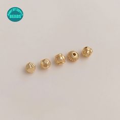 three different types of gold ear studs on a white surface with the words bead's above them