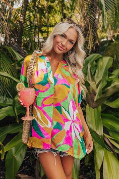 - Take a trip to paradise in this vibrant top! - Unlined material with a pink, yellow, and green hued abstract tropical print and a satin finish - A v-cut neckline with a pleated detail - Short draped sleeves - An oversized silhouette that ends in a straight hemline Draped Sleeves, Drape Sleeves, Yellow And Green, Oversized Silhouette, V Cut, V Cuts, Tropical Print, Satin Finish, Pink Yellow