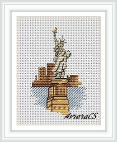 the statue of liberty cross stitched on a white frame