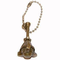 an antique brass bell is hanging from a ball chain