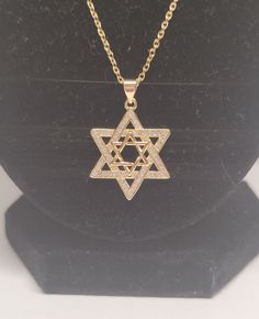 Gold plated and cubic zerconia star of David necklace Width: 2CM Height: 3CM Chain length: 50CM Star-shaped Sparkling Cubic Zirconia Necklaces, Star-shaped Cubic Zirconia Diamond Necklace Gift, Star-shaped Clavicle Chain With Cubic Zirconia, Star Of David Necklace In Cubic Zirconia As Gift, Gold Diamond Necklace With Star Of David For Gift, Gold Cubic Zirconia Star Of David Necklace, Gold Star-shaped Cubic Zirconia Necklace, Gold Star-shaped Diamond Necklace, Gold Cubic Zirconia Necklace With Star Charm