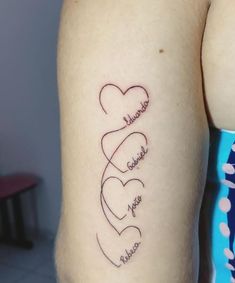 two hearts with names tattooed on the back of their arm and behind them is another heart