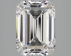 an emerald cut diamond is displayed on a gray background, with the center stone visible