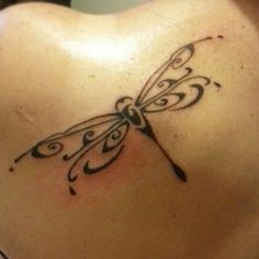 a woman's back with a butterfly tattoo on it