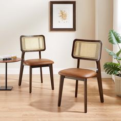 two chairs sitting next to each other on top of a hard wood floor