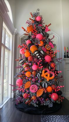 a brightly colored christmas tree with candy decorations