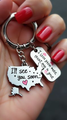 a woman's hand holding a keychain that says i'll see you soon