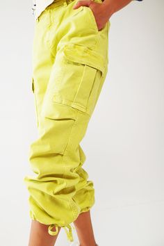 Introducing our Cargo Pants with Tassel Ends in Lime, a stylish and comfortable choice for a casual yet fashionable look. These ankle-length pants are designed to provide a relaxed and effortless fit. With a relaxed fit and straight leg, these cargo pants offer a laid-back style that is perfect for everyday wear. The comfortable fit allows for easy movement, while the straight leg design adds a touch of versatility. Crafted from stretch denim, these pants provide a comfortable and flexible feel. Yellow Five-pocket Pants For Spring, Spring Yellow Pants With Five Pockets, Trendy Tapered Leg Cargo Pants With Five Pockets, Casual Cargo Pants With Loosely Fitted Hips, Spring Cargo Jeans With Loosely Fitted Hips, Trendy Yellow Pants With Pockets, Loose Fit Straight Cargo Jeans For Spring, Loosely Fitted Straight Cargo Jeans For Spring, Urban Tapered Leg Cargo Pants For Spring