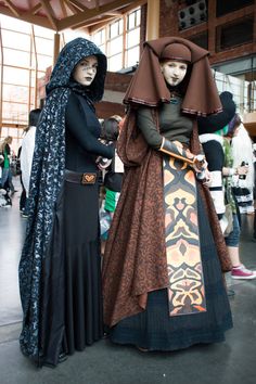 two women dressed in costumes standing next to each other