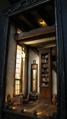 a mirror reflecting a room with bookshelves and furniture