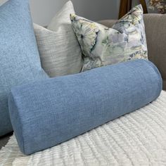 the pillows on the couch are blue and have white flowers all over them, while the rest of the pillow is light blue