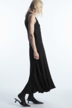 The COS womenswear team looked to classic lingerie when designing this modern midi dress. Crafted from fluid TENCEL™ Lyocell-blend satin, it's shaped in a floaty silhouette that's enhanced by the asymmetric hemline, contrasting panels and bodice-defining seams. Frame the V-neckline with a statement necklace. Relaxed fitSleevelessTENCEL™ is a trademark of Lenzing AG. TENCEL™ Lyocell is made from renewable wood sources, using a process that recycles 99% of all chemicals and water 66% Viscose, 34% Fitted Modal Satin Dress For Daywear, Modern H-line Midi Dress For Evening, Spring Midi-length Asymmetrical Satin Dress, Viscose Bias Cut Dress For Daywear, Spring Asymmetrical Satin Midi Dress, Sleek Asymmetrical Maxi Dress, Sleeveless Modal Satin Midi Dress In Bias Cut, Asymmetrical Satin Midi Dress With Bias Cut, Satin Midi Dress With Bias Cut And Asymmetrical Hem