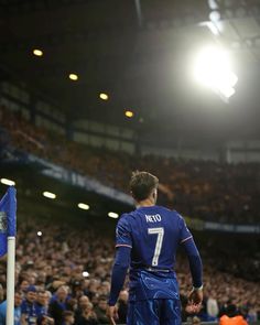 a soccer player is standing on the field