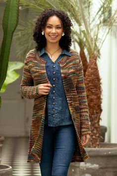 a woman is walking down the street wearing jeans and a cardigan jacket with buttons