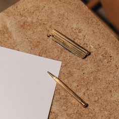 a notepad and pen sitting on top of a table