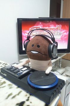 a stuffed animal with headphones sitting on top of a turntable