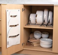 an open cabinet with plates and bowls in it