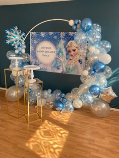 a frozen princess balloon arch with blue and white balloons