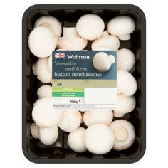 white mushrooms in a black container on a white background