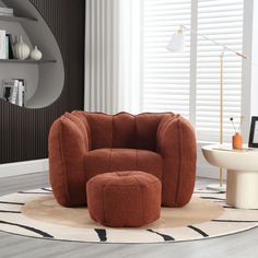 an orange chair and ottoman in a living room with white rugs on the floor