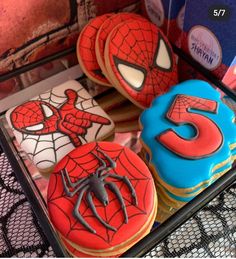 spiderman cookies and cupcakes are on display