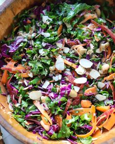 a wooden bowl filled with lots of salad