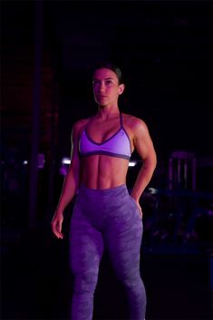 a woman in purple sports bra top and leggings