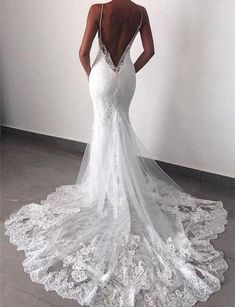 a woman in a white wedding dress looking back