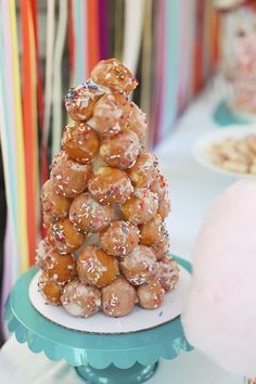 a small christmas tree made out of donuts on a table with other desserts