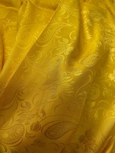 the yellow fabric has an intricate pattern on it