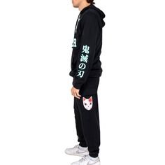 Celebrate your favorite anime series in comfort with this Demon Slayer hoodie & jogger set. Images of Tanjiro's cat mask decorate the sweatshirt and sweatpants while white varsity text on the hoodie spells out the series title. The sweatshirt comes in black with an adjustable hood and a large pouch pocket while the black jogger pants come with a drawstring waistband. Demon Slayer fans will love this comfy set. Demon Slayer Hoodie, Hoodie Jogger Set, Fox Mask, Black Hoodie Men, Black Jogger Pants, Comfy Sets, Cat Mask, Large Pouch, Masked Man