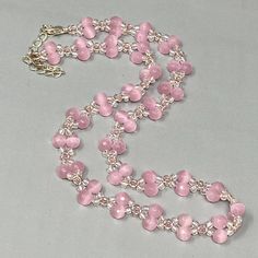 a pink beaded necklace on a silver chain