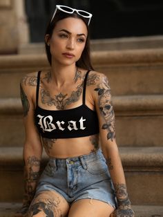 Witchwood Bags' Brat bralette. This cute, black, and sporty bralette features a Brat graphic in white. Wear it on its own or under a shirt with shorts! Cotton Janice is wearing an extra small Made in the United States Short Denim Shorts, Angel Dress, Shorts Cotton, Body Reference Poses, Tattooed Girls, Short Denim, Tattooed Women, Black Joggers, Beauty Tattoos