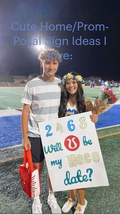 a man and woman standing next to each other on a field holding a sign that says, how do my hoco date?