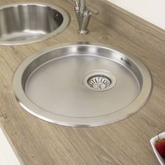 a stainless steel sink and counter top with strawberries