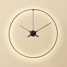 a circular clock with black hands on a white wall