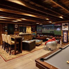 a game room with a pool table, foosball and television