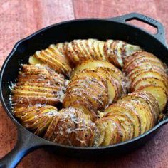 baked potatoes in a cast iron skillet ready to be cooked for dinner or dessert