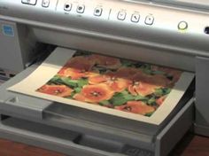 an image of a printer with flowers on it's paper in front of the camera