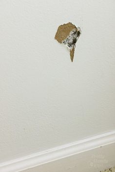 the corner of a wall with a hole in it