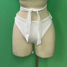 -Self: 82% Nylon, 18% Elastane Lining: 88% Poly, 12% Elastane -Machine Wash -Attached Side Tie Detail -High Waist Fitted Lined Swimwear With Tie-side Bottom, White Polyamide Swimwear For Pool, Fitted Lined Tie-side Swimwear, White Polyamide Swimwear For Vacation, Party Swimwear With Tie-side Bottom In Nylon, Party Swimwear With Tie-side Bottom, White Stretch High-waist Swimwear, White High-waisted Stretch Swimwear, Fitted White Bottoms With Lined Body