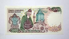 an omani bank note with the image of a man in green robes and a hat