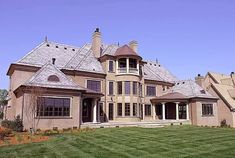 a large house with many windows and lots of grass