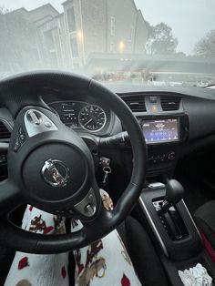 the interior of a car is covered in snow and ice as it drives down a city street