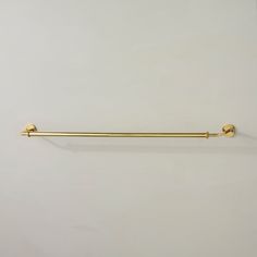 a white wall with a gold handle on it