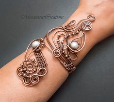 "Unique and original design of bracelet cuff. This is a very stylish bracelet and can be worn with any kind of outfit. This bracelet is carefully handcrafted made out of thick pure copper wire and wrapped with silver pearls 9mm. Bracelet is adjust size up to diameter minimum 2.5\" to ,2.7\" maximum . Bracelet is easily adjusted with light pressure to custom fit your wrist. Your bracelet will arrive well packed inside a box with padded envelope. If you have any questions about it, please do not h Elegant Hand Wrapped Copper Bangle, Unique Design Cuff Bracelet Gift, Elegant Wire Wrapped Copper Cuff Bracelet, Elegant Copper Wire Wrapped Cuff Bracelet, Elegant Copper Cuff Bracelet, Elegant Copper Bracelets As Gift, Elegant Copper Bracelet As A Gift, Elegant Copper Bracelets For Gift, Elegant Copper Bracelet For Gift