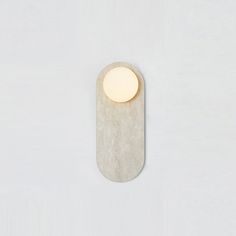 a light that is on the side of a wall with a white surface behind it