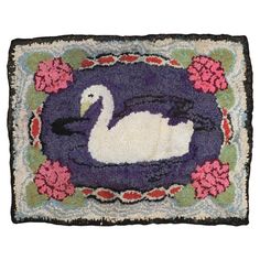 a rug with a swan on it and flowers around the edges is shown in purple